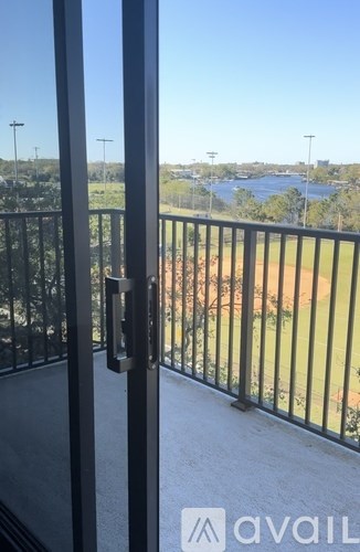 A balcony with a view of a baseball field.