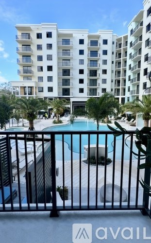 A pool is surrounded by a black fence.