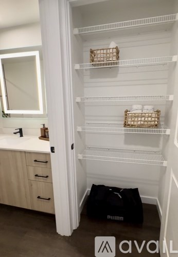 A bathroom with a white cabinet and a mirror.