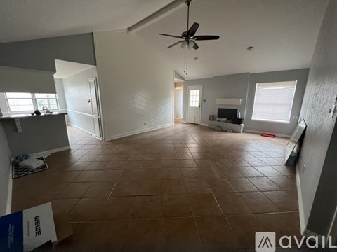 A room with a tiled floor and a ceiling fan.