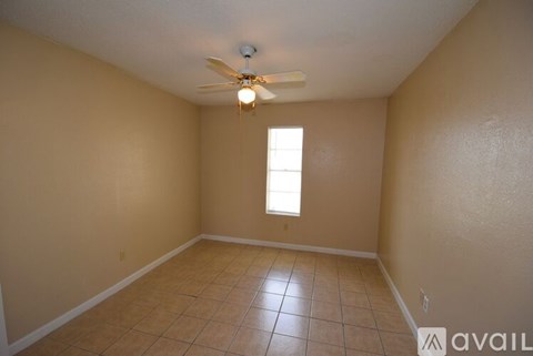 A room with a ceiling fan and a window.