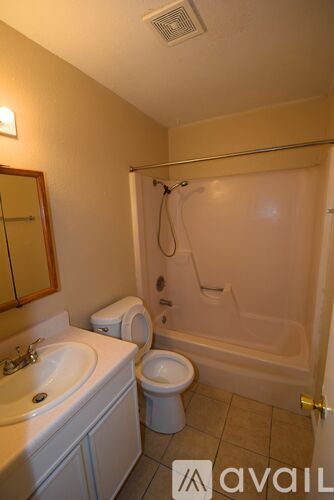 A bathroom with a toilet, sink, and bathtub.