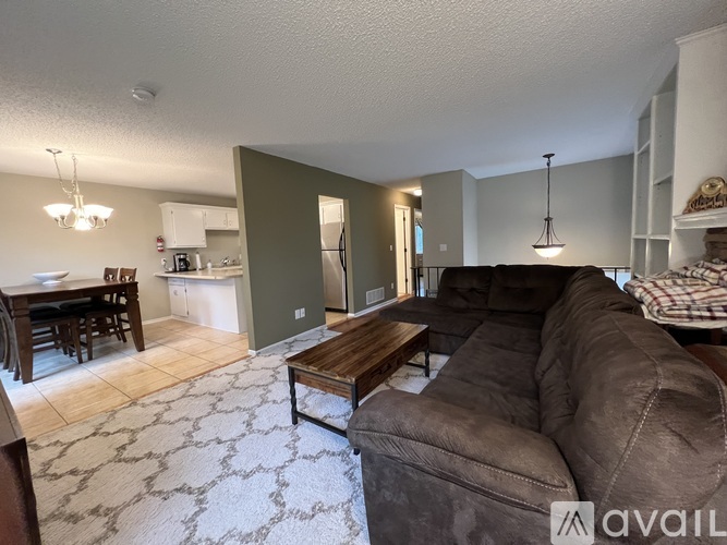 A kitchen with white cabinets and a tiled floor.