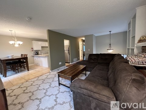 A kitchen with white cabinets and a tiled floor.