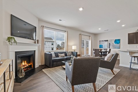 A modern living room with a fireplace and a television mounted on the wall.