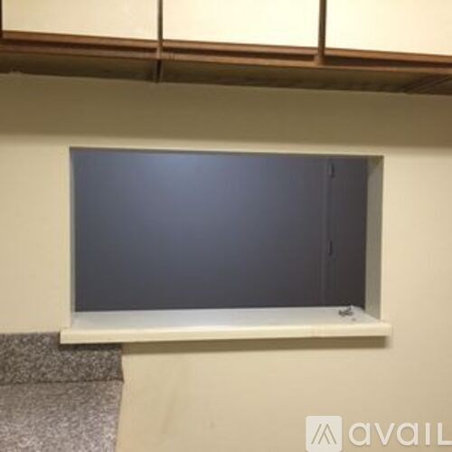 A window in a room with a grey carpet.