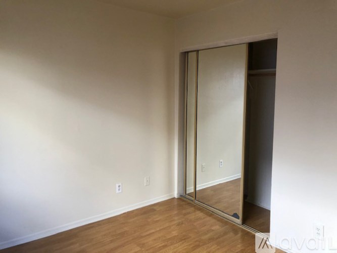 A room with a sliding door and wooden flooring.