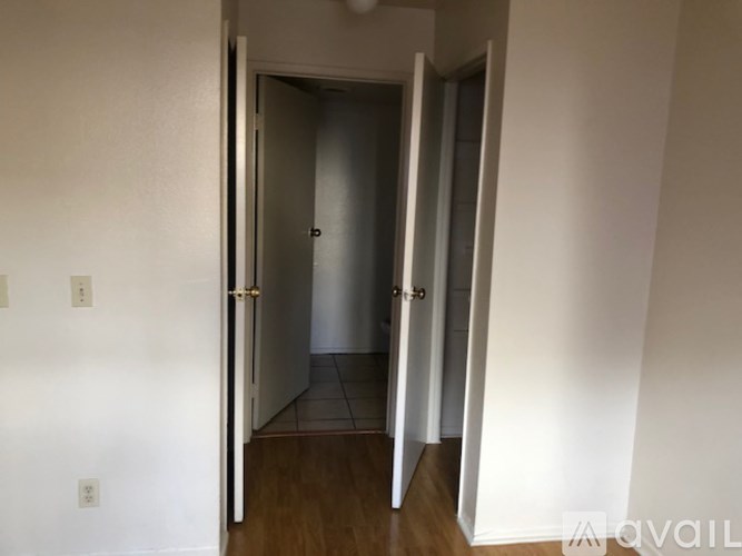A hallway with a door on the left and another door on the right.