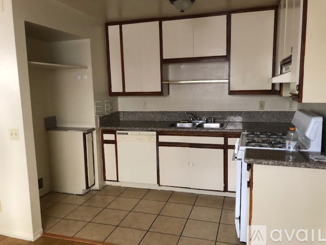 A kitchen with white appliances and cabinets.