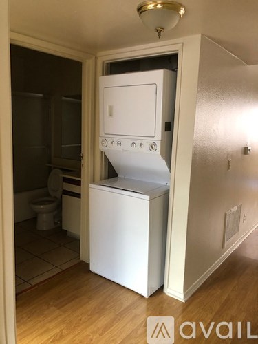A white oven with a door open in a kitchen.