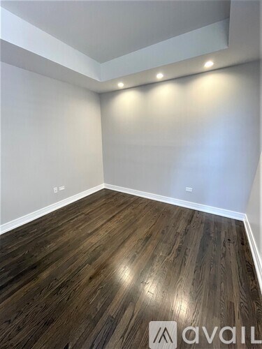 A room with wooden flooring and a logo that reads "avail".