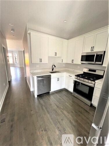 A kitchen with white cabinets and stainless steel appliances.