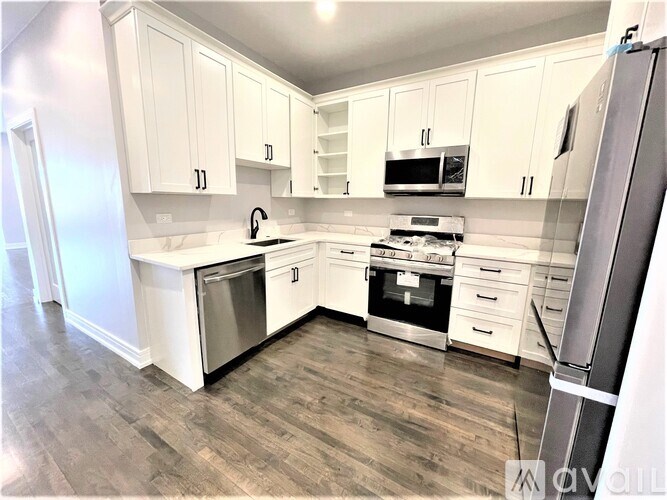 A kitchen with white cabinets and stainless steel appliances.