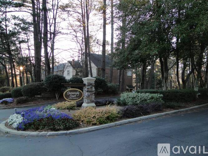 The entrance to a residential area with a sign that reads "Pinecrest".