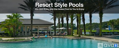 A resort style pool with people enjoying the water.