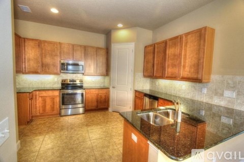A kitchen with wooden cabinets and a stainless steel oven.