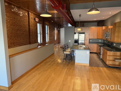A kitchen with a table and chairs.