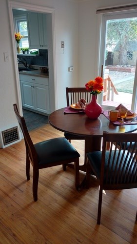 A dining room with a table and chairs.