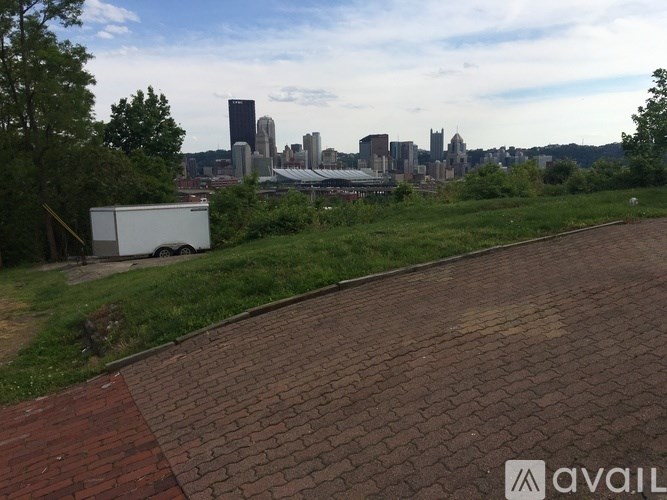 A white truck is parked on a brick path.