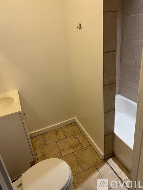 A bathroom with a toilet and a shower.