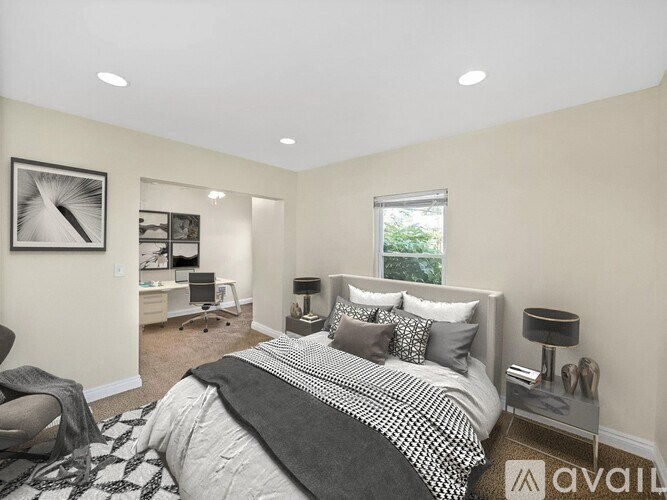 A bedroom with a large bed and a chair.