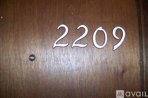 A wooden surface with the number 2209 engraved on it.