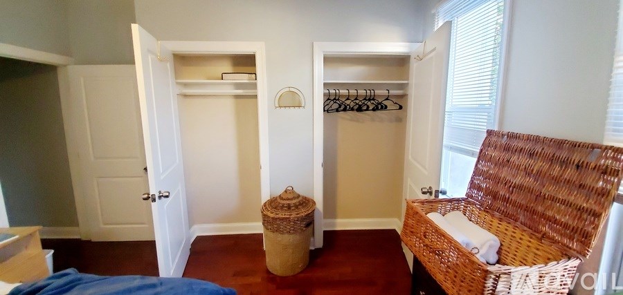 A room with a wicker sofa and a wicker basket.