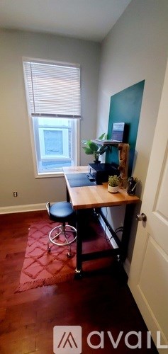 A room with a desk and a chair.