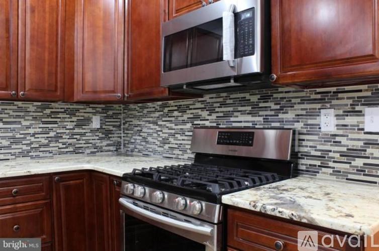 A kitchen with a stove top oven and microwave above it.