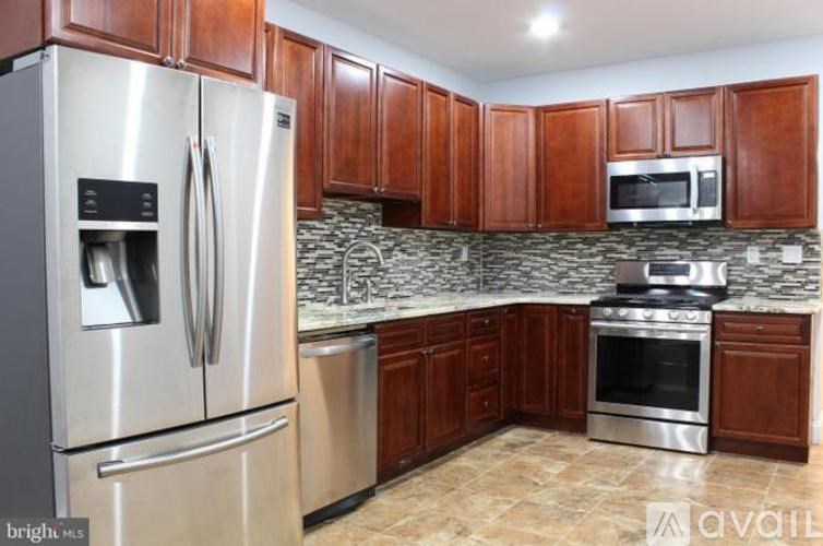 A kitchen with wooden cabinets and stainless steel appliances.