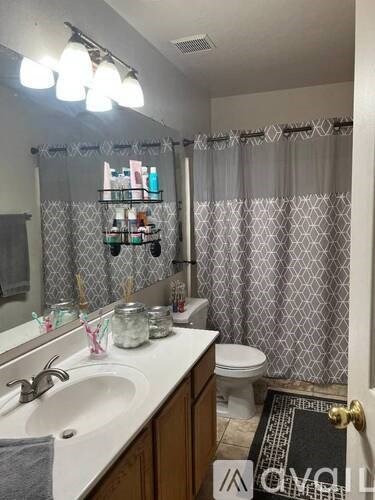 A pool in a backyard with a house and trees in the background.