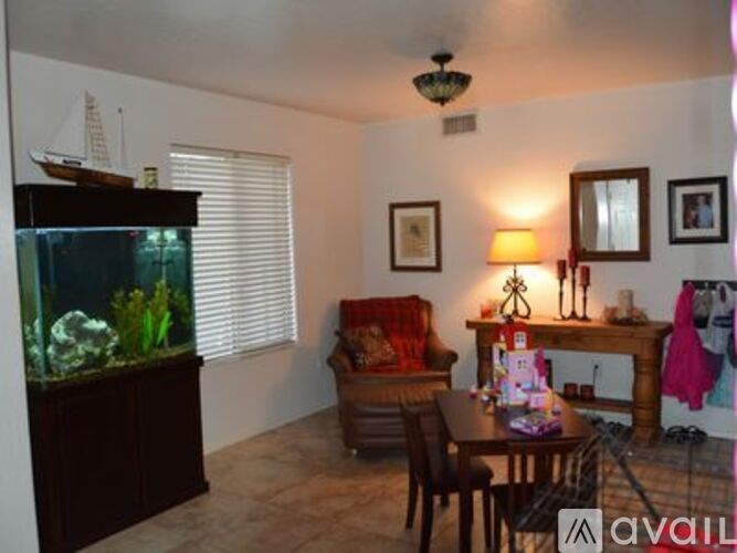 A living room with a fish tank, a sofa, a table, and a lamp.
