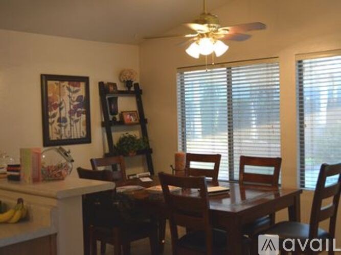 A dining room with a table and chairs.