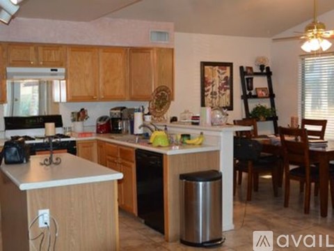 A kitchen with wooden cabinets and a dining table with chairs.