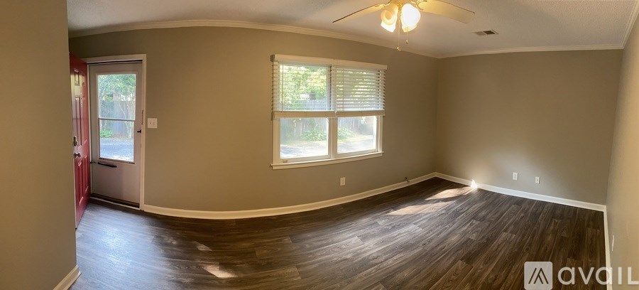 A room with a wooden floor and a ceiling fan.
