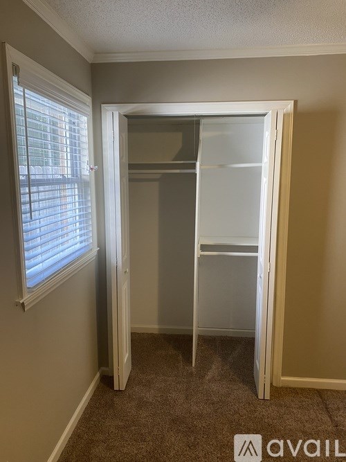 A room with a carpeted floor and a white door.
