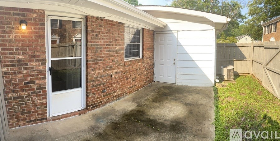 A house with a white garage door and a brick wall.