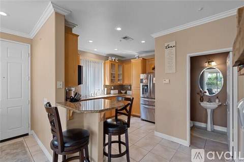 A kitchen with a bar area and a sink.