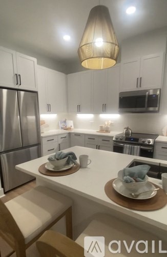 A kitchen with a white countertop and a refrigerator.