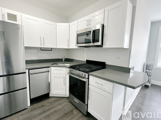 A kitchen with white cabinets and stainless steel appliances.