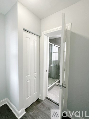 A white door is open to a hallway.