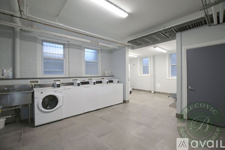 A laundry room with washers and dryers.