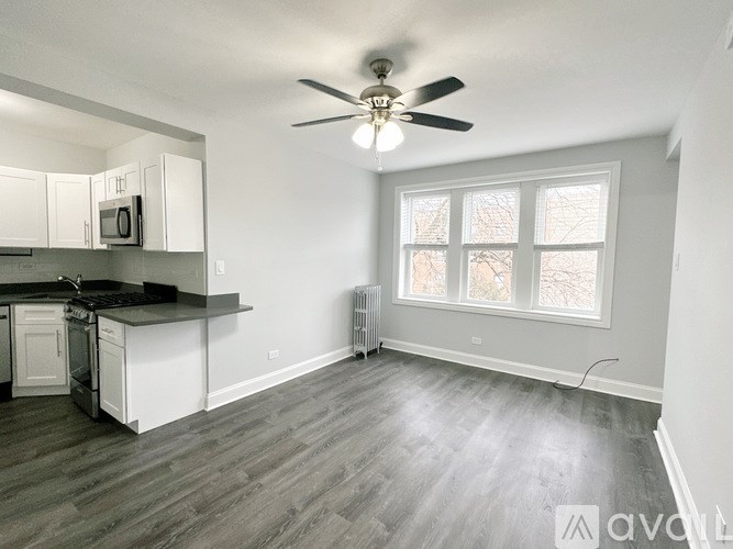 A kitchen with a fan and a window.
