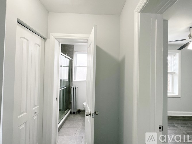 A hallway with a door on the left and a door on the right.