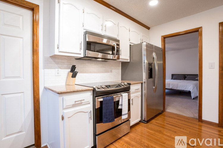 A kitchen with white cabinets and stainless steel appliances.