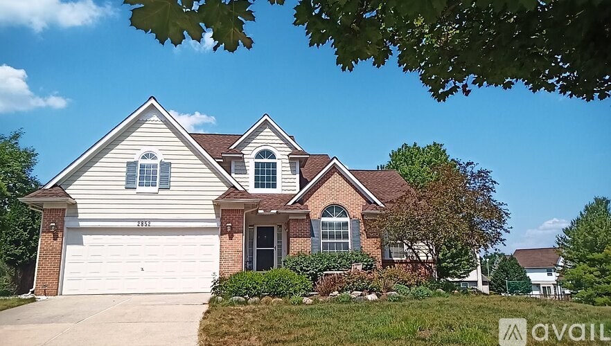 A house with a garage and a driveway is for sale.