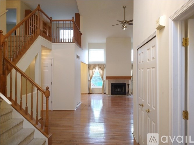 A spacious living room with a staircase leading to the upper floor.