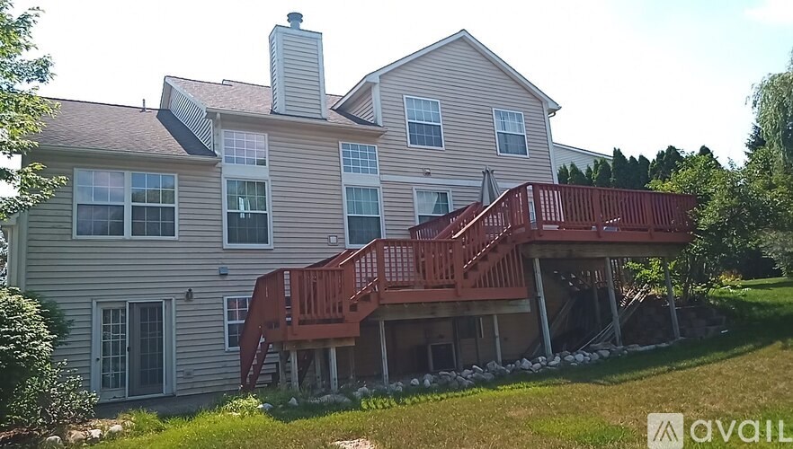 A house with a red deck and a chimney.