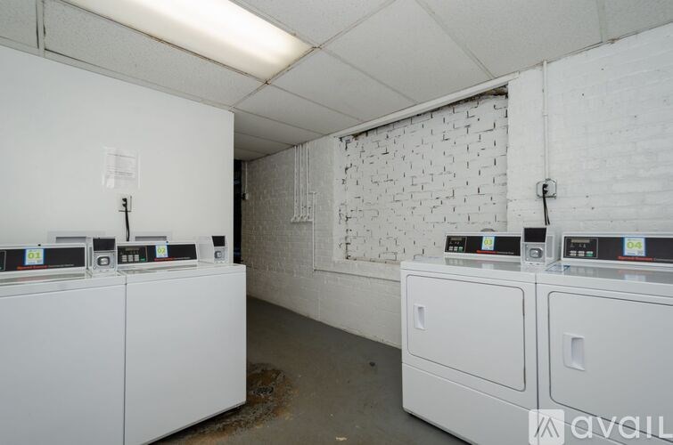 A laundry room with washers and dryers.