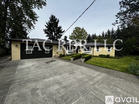 A house with the text "TACRBRLLC" on the garage door.